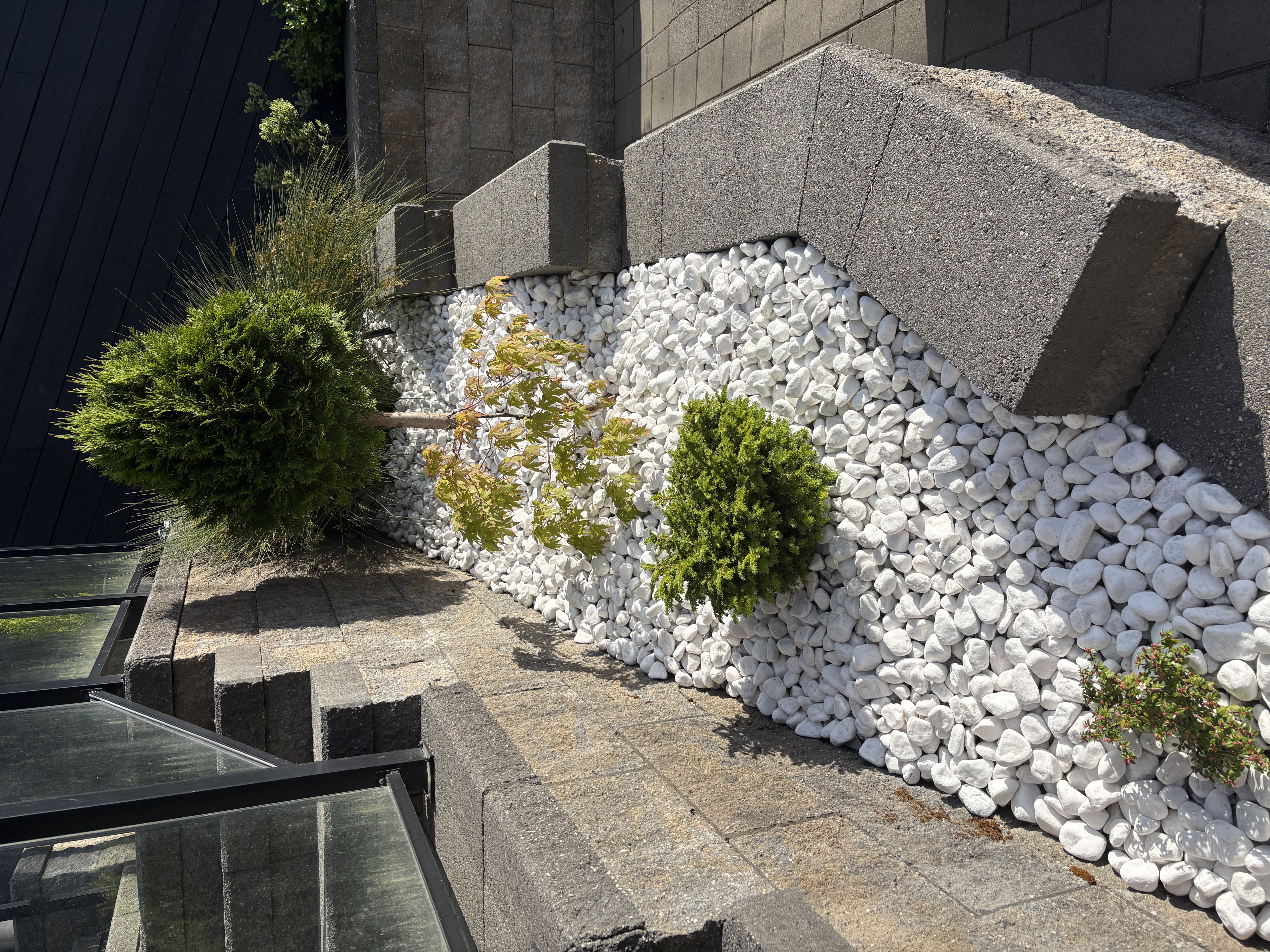 Rock garden bed with ornamental plantings in Metro Vancouver, BC by Coastal Property Services